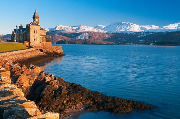 Standing proudly by the serene lake, this historic building boasts a traditional clock tower and stunning mountain views.