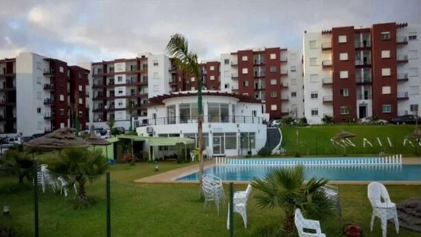 A residential building with multiple floors, a swimming pool, and outdoor seating. - Atlantic Ocean Residence 3044 (Asilah)