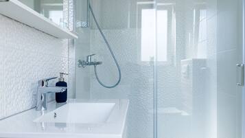 Shower, hair dryer, towels, toilet paper