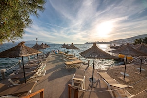 Private beach, white sand, sun loungers, beach umbrellas
