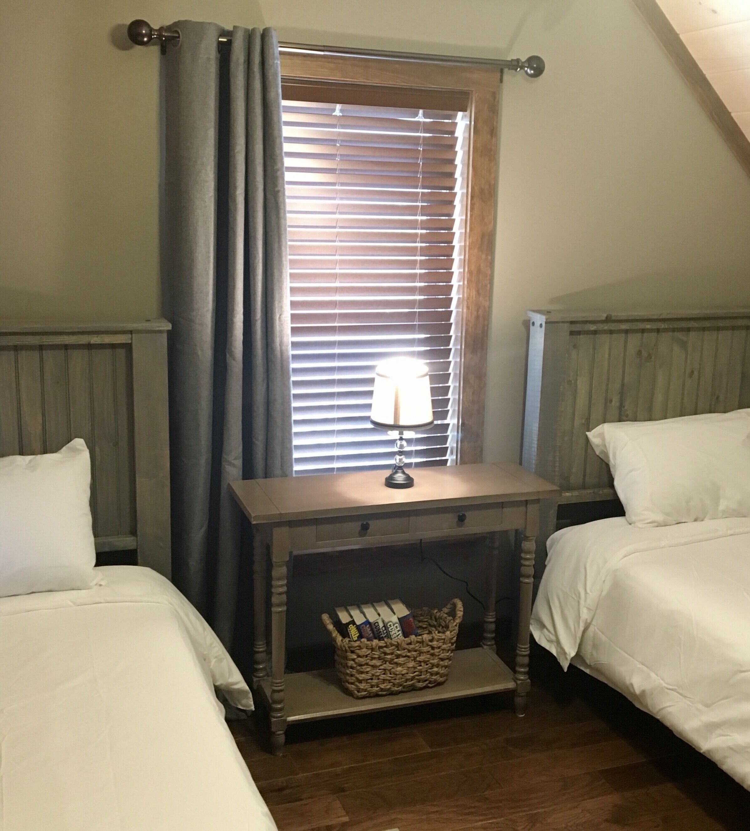 “Steelhead Room” with two twin beds and ceiling fan on loft level 