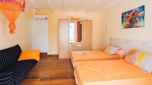 A room with two beds, a sofa, and a wardrobe. - Villa Man Cina (Capesterre-Belle-Eau)