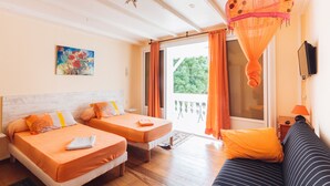 A room with two beds, a sofa, a painting, and a large window with curtains. - Villa Man Cina (Capesterre-Belle-Eau)