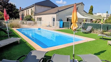 Seasonal outdoor pool, open 8:00 AM to 10:30 PM, pool umbrellas