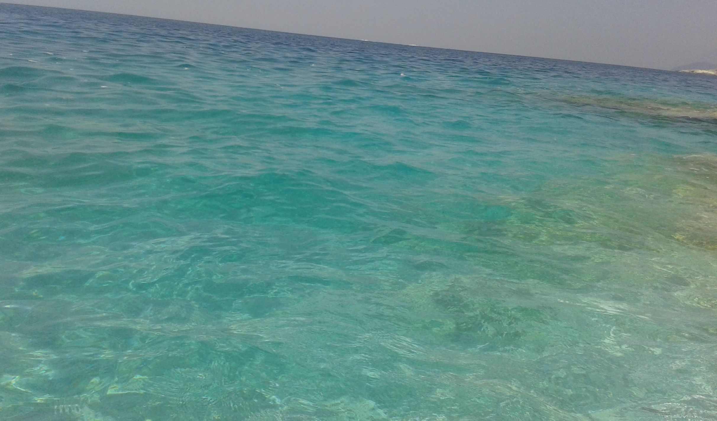 Clear turquoise water at a beach.