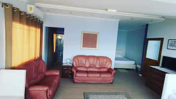 Deluxe Suite, Multiple Beds, Sea View | Living area | LCD TV