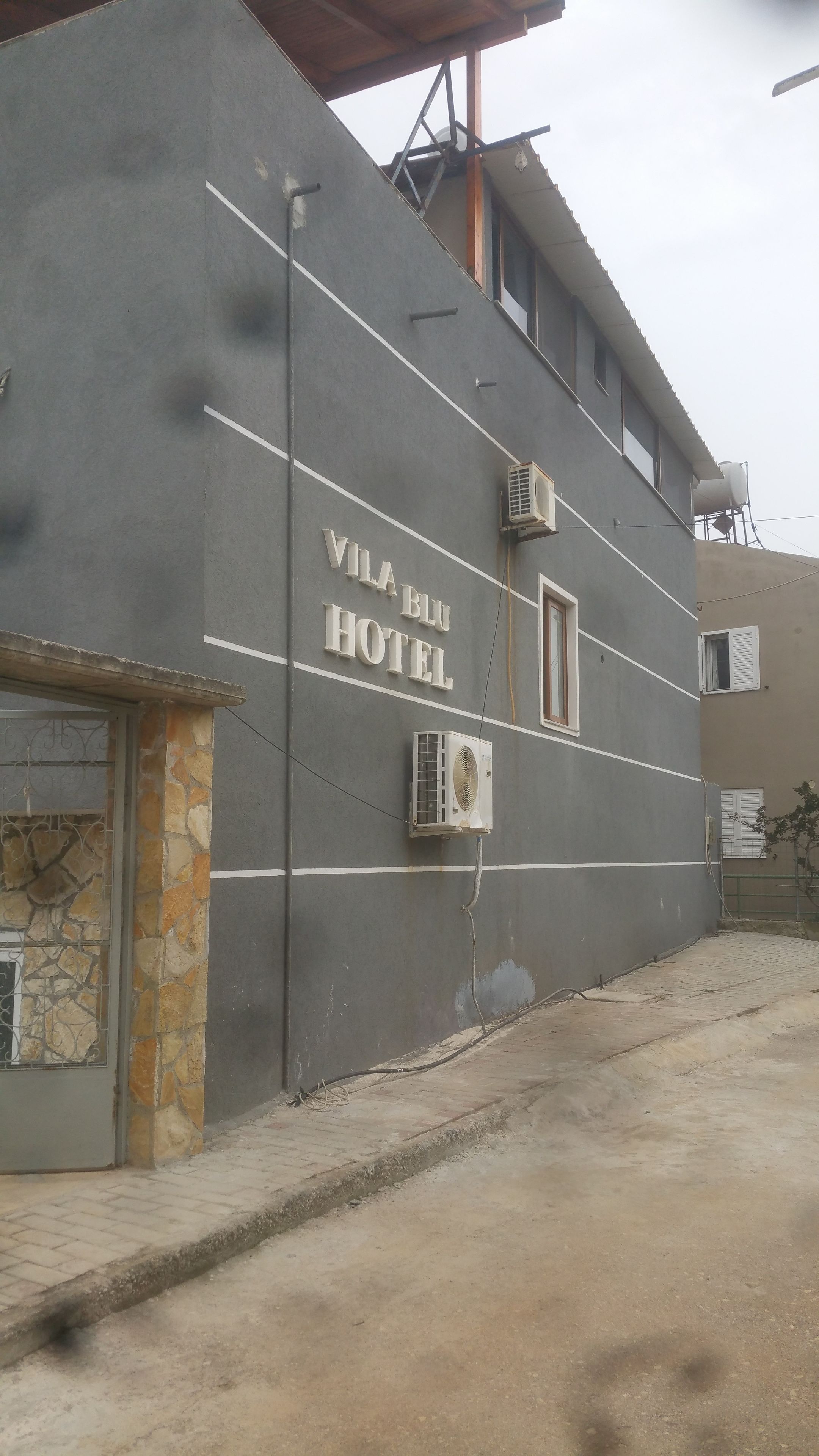 A building with a sign reading "VILA BLU HOTEL".