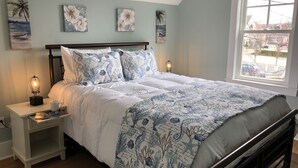 A bedroom with a bed, nightstands, a window, and wall art. - Location, Location, Location! Downtown Newport! Newly Renovated (Newport)
