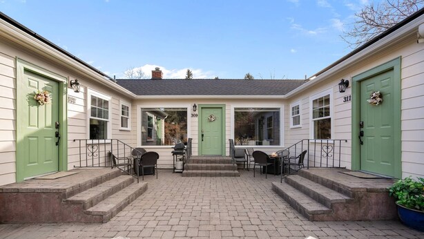 A two-story house with green doors and a covered patio area. - Historic Drake Cottage - Walk to Downtown Bend - Drake Park Across the Street - Perfect for Couples (Bend)