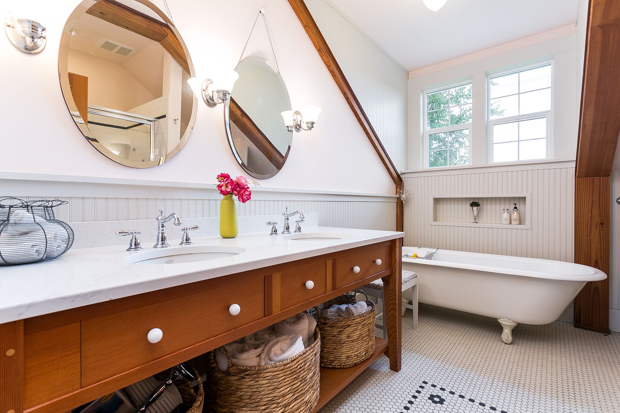 Bathroom with claw foot tub, double sink in a custom vanity and tiled shower