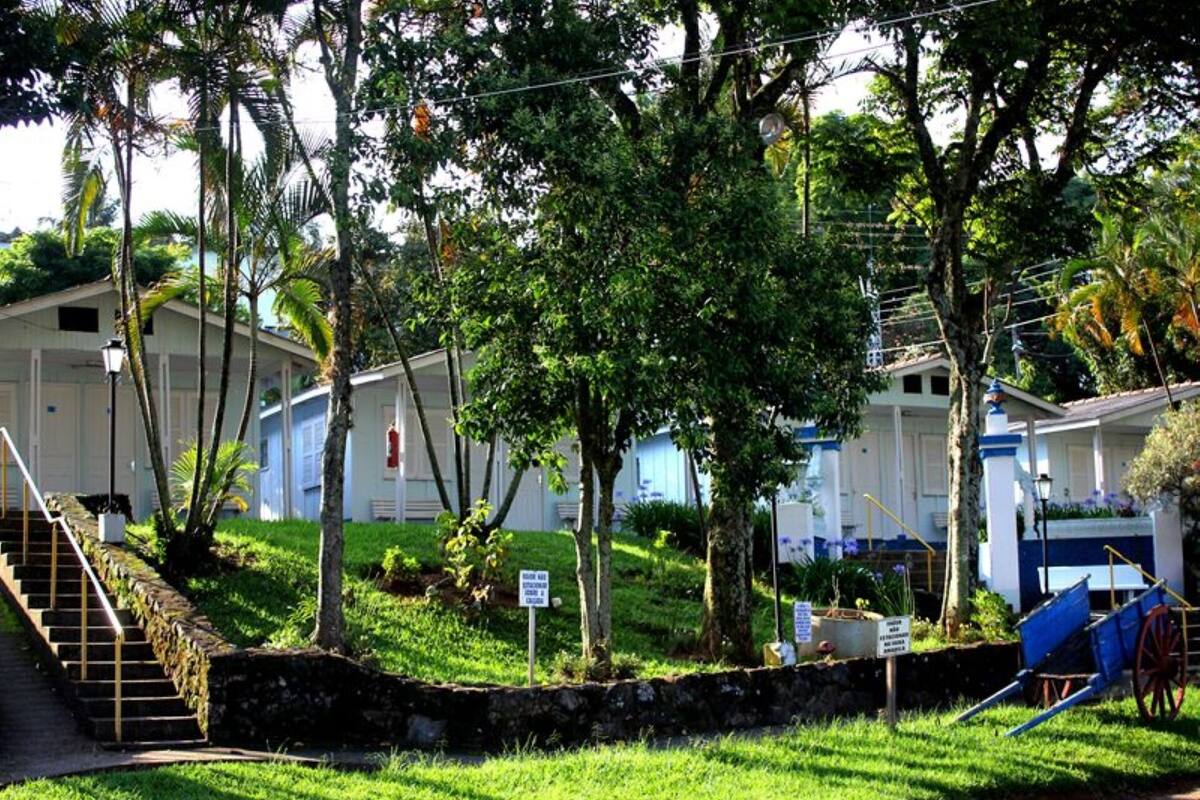 A row of mobile homes with a stone wall and stairs leading up to the entrance.