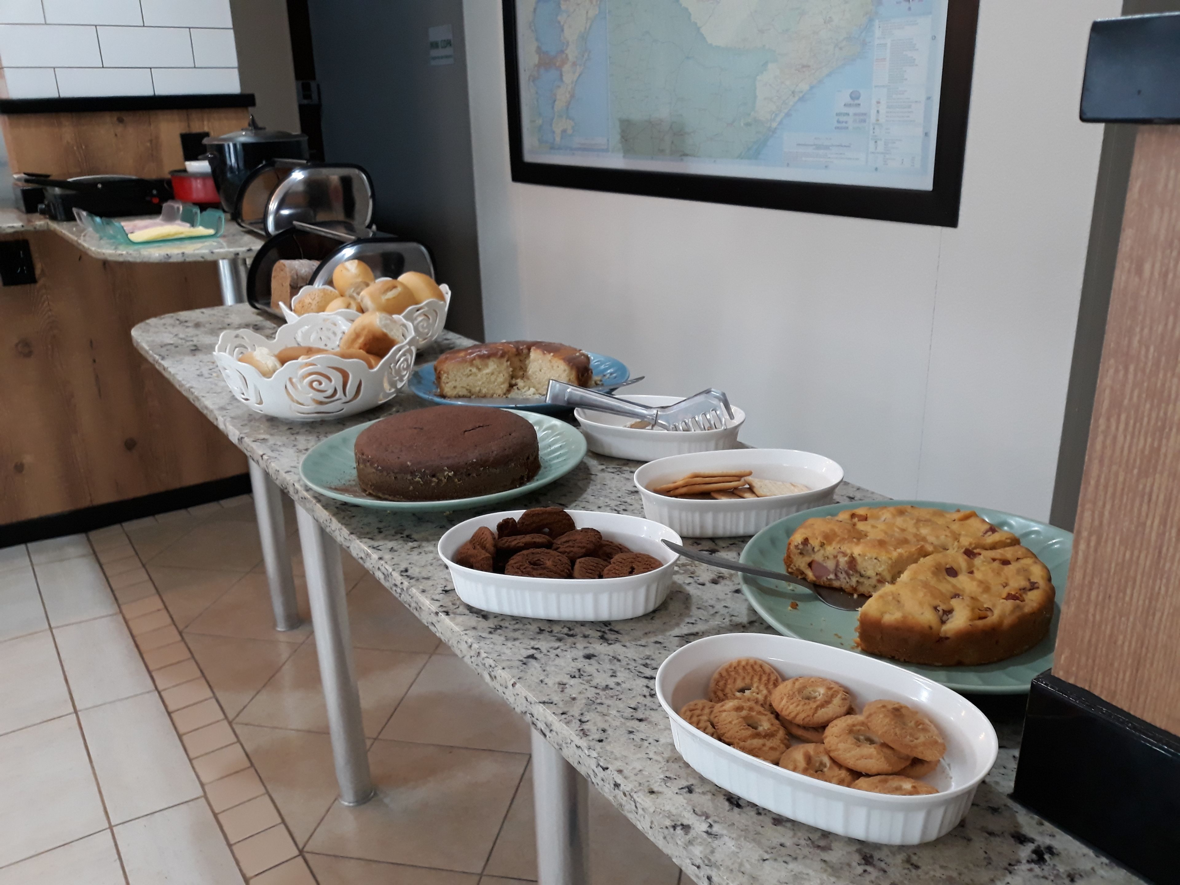 A kitchen counter with various baked goods including cakes, cookies, and pastries.