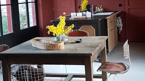 A dining area with a table, chairs, and a hanging light fixture. - Beautiful view of Baume les Messieurs (Baume les Messieurs)