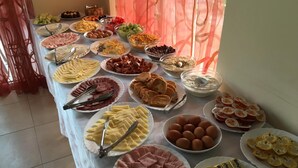 A buffet table with various food items including meats, cheeses, fruits, and desserts. - Hotel Beatris (Nessebar)