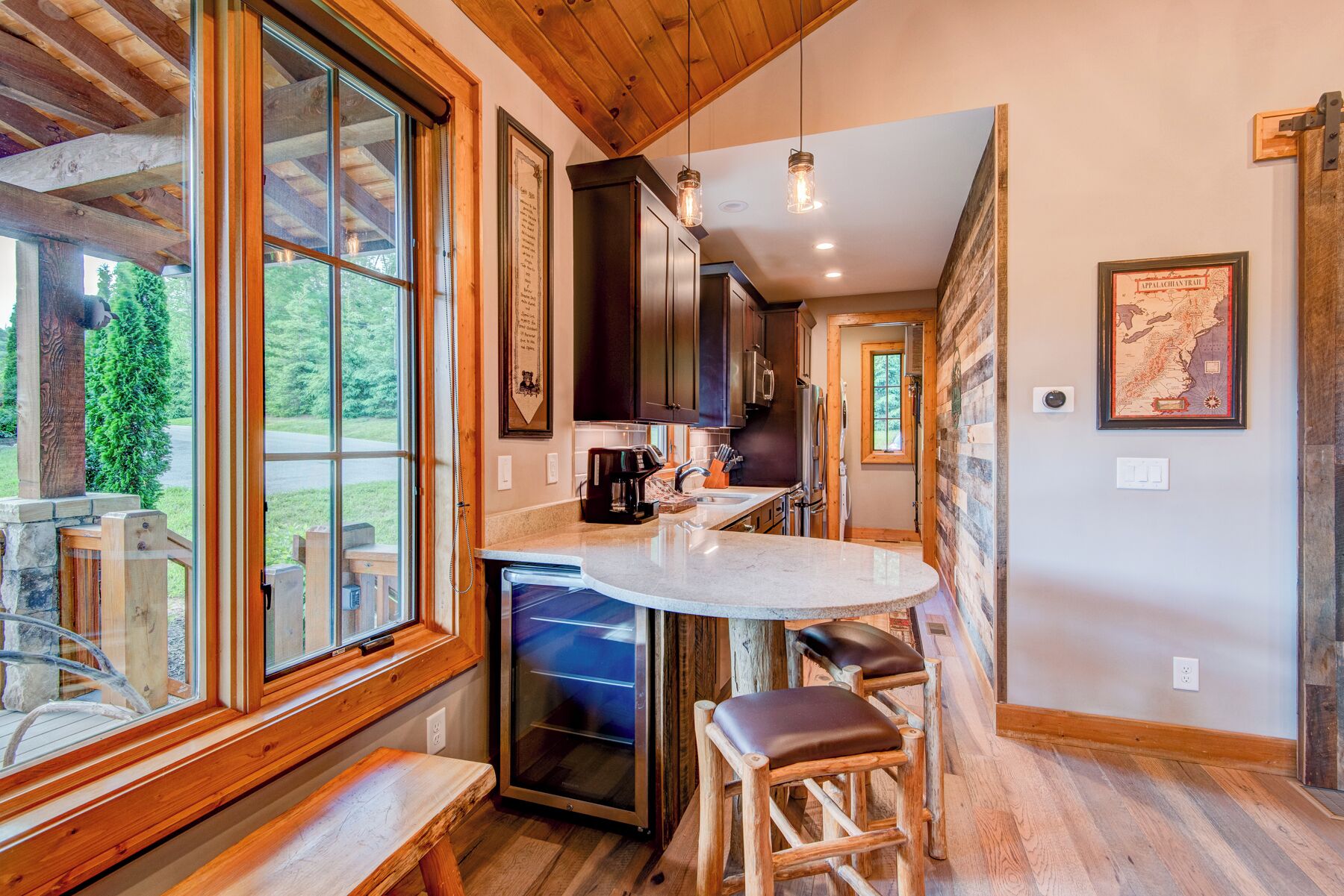 A kitchen with wooden cabinets, a built-in stove, and a large window.