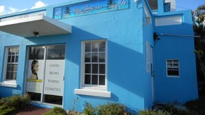 A blue building with a sign for 'Blue Horizons Guest House' and a statue of an eagle. - Blue Horizons Guest House - Room # 7 (Hamilton)