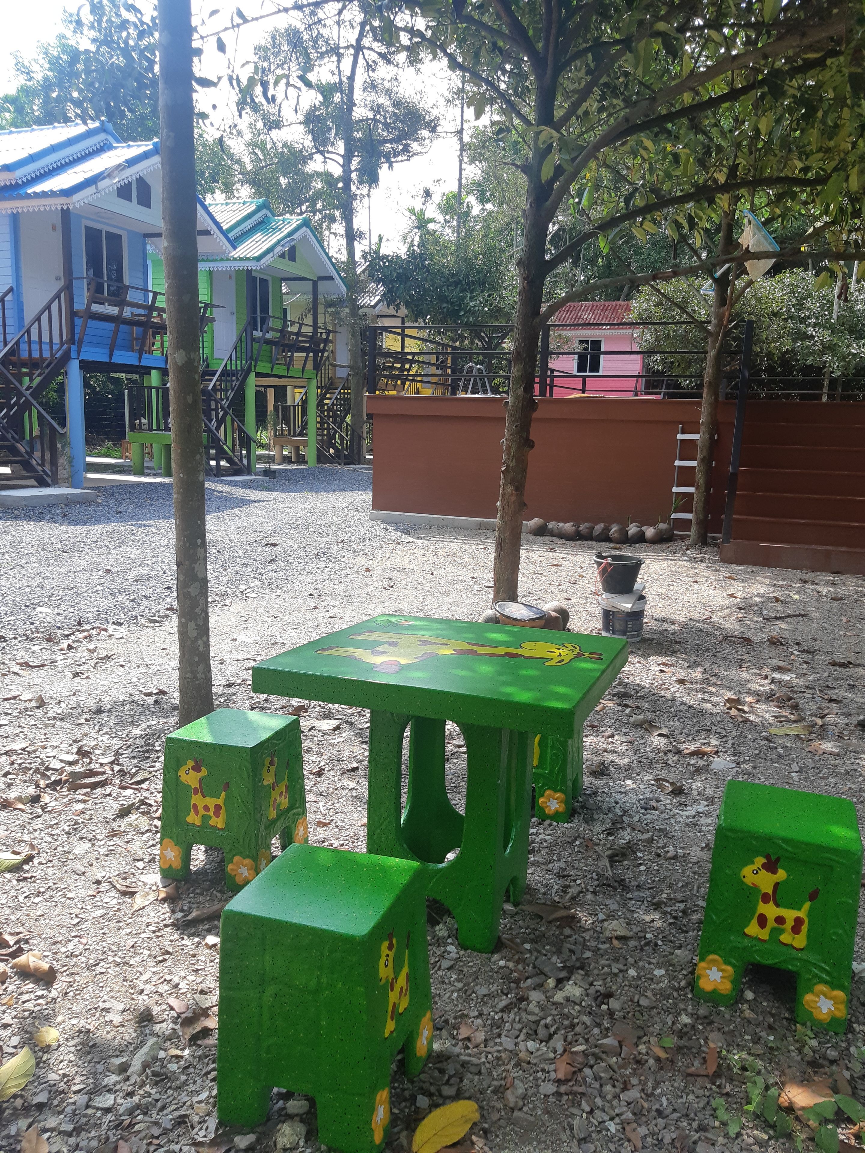 A playground with green play structures and a table.