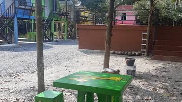 A playground with green play structures and a table.