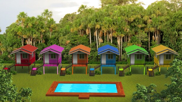 Een rij kleurrijke bungalows met een zwembad op de voorgrond.