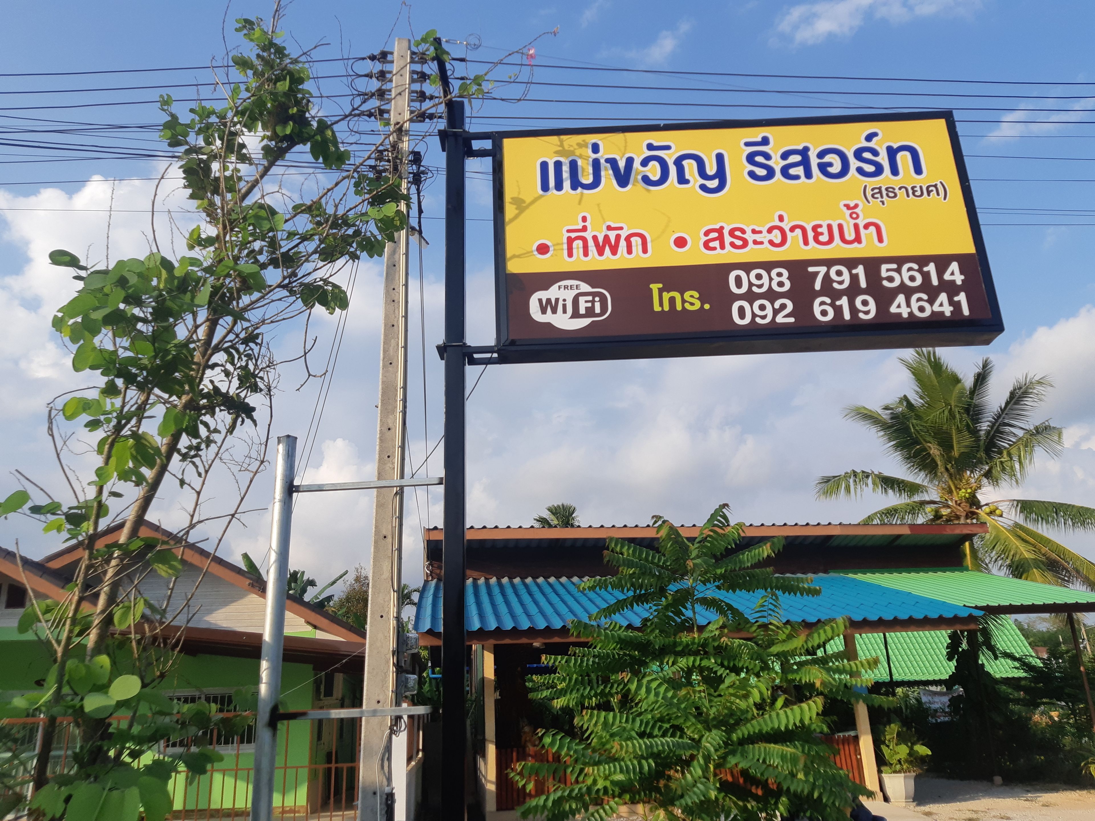 A signboard with contact information and WiFi availability for a business.