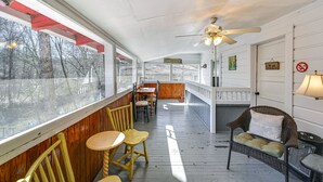 A covered porch with wooden flooring, a ceiling fan, and a view of the outdoors. - Cleveland Home w/ South Saluda Fishing Access (Cleveland)
