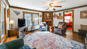 A cozy living room with a television, a fireplace, a ceiling fan, and a large rug. - Cleveland Home w/ South Saluda Fishing Access (Cleveland)