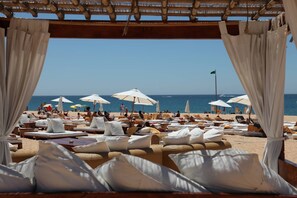 On the beach, sun-loungers, beach towels