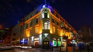 A historic building with ornate architecture, featuring a prominent corner entrance and multiple stories. - Tiflis Opera Aparthotel (Tbilisi)
