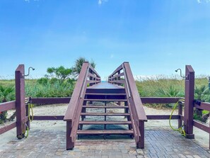 A wooden bridge with a metal railing leading to a beach. - Beach Club I 3E (North Myrtle Beach)