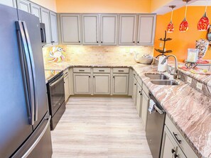 A kitchen with a refrigerator, oven, sink, and cabinets. - Beach Club I 3E (North Myrtle Beach)