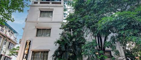 A multi-story building with a sign for 'GUEST HOUSE' indicating a guest accommodation.