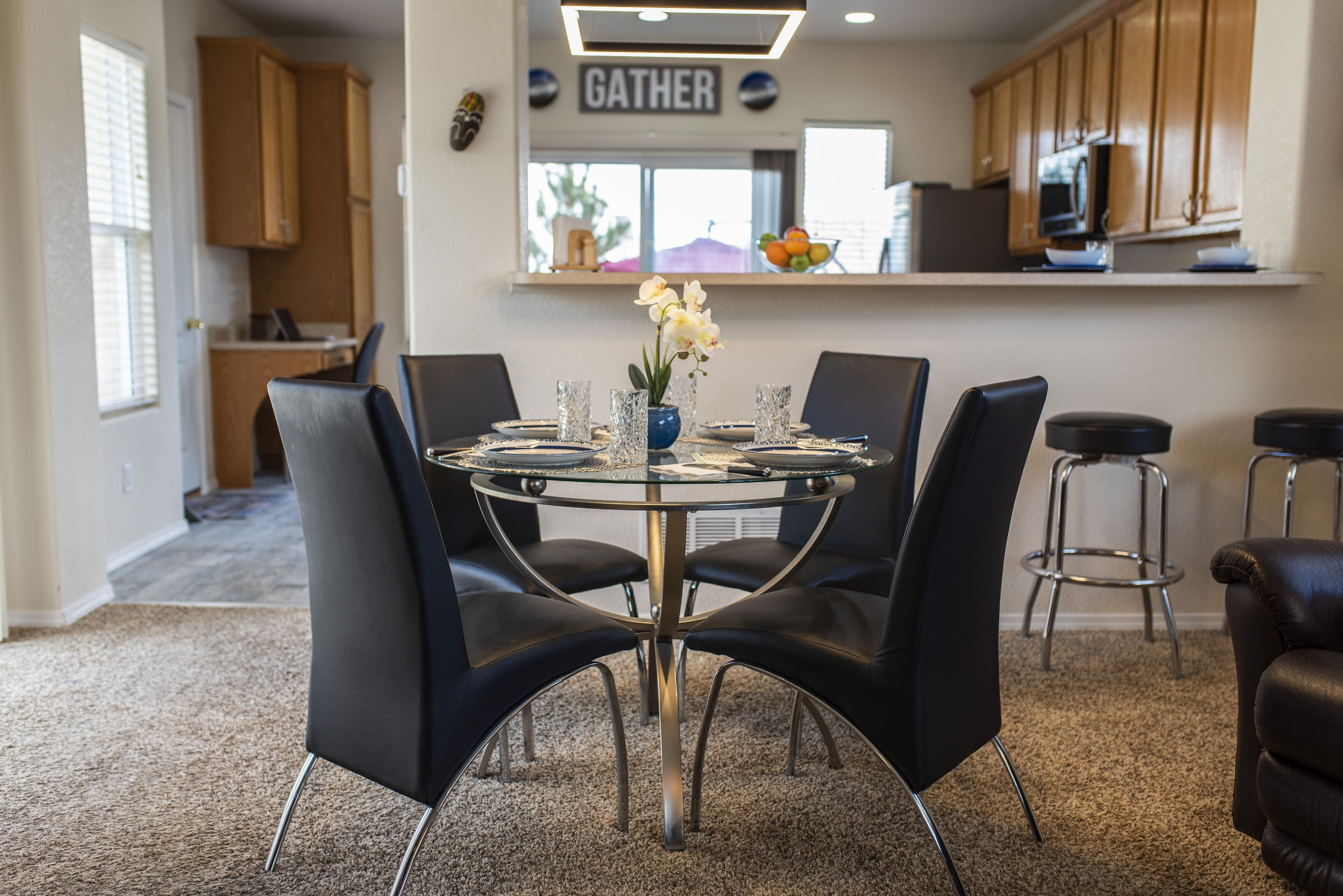 A modern kitchen with wooden cabinets, a microwave, and a countertop.