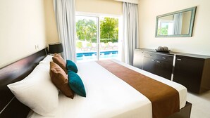 A hotel room with a bed, a desk, a chair, and a view of a pool. - Villa Fortuna Iberostar, private pool,  Bavaro beach, golf club, Wi-Fi (bavaro)