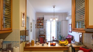 A kitchen with a blender, toaster, and various kitchen items on the counter. - Happy place at the foot of Acropolis. (Athens)
