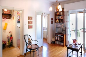 Entrance, living room, secondary room & front balcony from the corridor's angle.