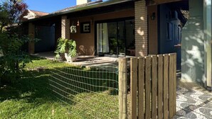 A residential house with a brick exterior, a covered porch, and a tiled patio. - Guaeca, the paradise of the North Coast. (São Paulo)