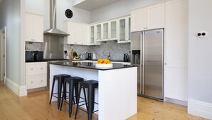 A modern kitchen with white cabinetry, a stainless steel refrigerator, and a marble countertop. - Charming Historic Home With Modern Interior - In The Heart Of Ballarat (Ballarat Central)