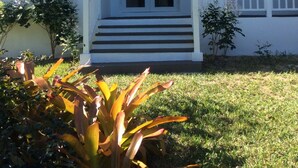 A house with a front porch, a double door, and a small set of steps leading to the entrance.