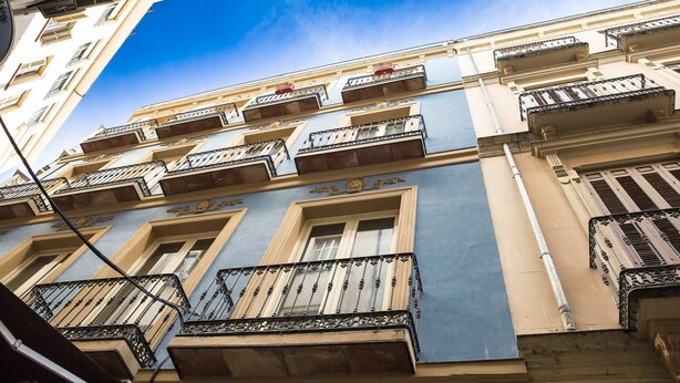 Un immeuble à plusieurs étages doté de balcons et de fenêtres.