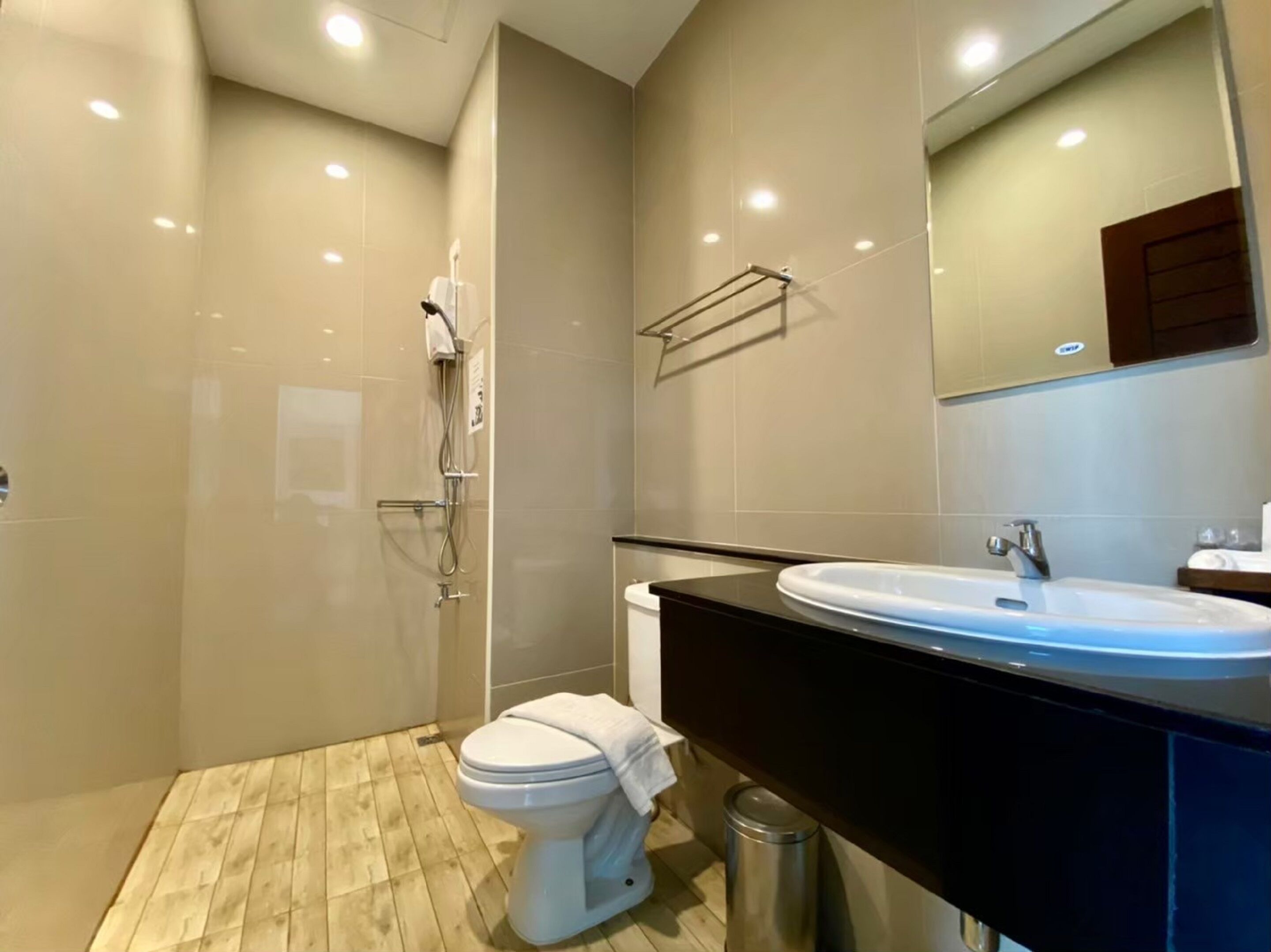 Un baño moderno con ducha, inodoro y lavamanos.