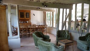 A rustic dining area with wooden furniture and a brick wall. - ---- The cottage --- (ST LEGER DE ROTES)