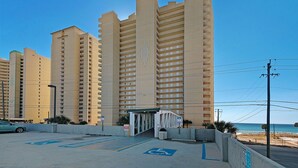 A high-rise hotel with multiple balconies and a parking area with handicapped accessibility. - Spectacular Ocean Villa END Unit 1001 - Coastal Decor and Endless Views! (Panama City Beach)