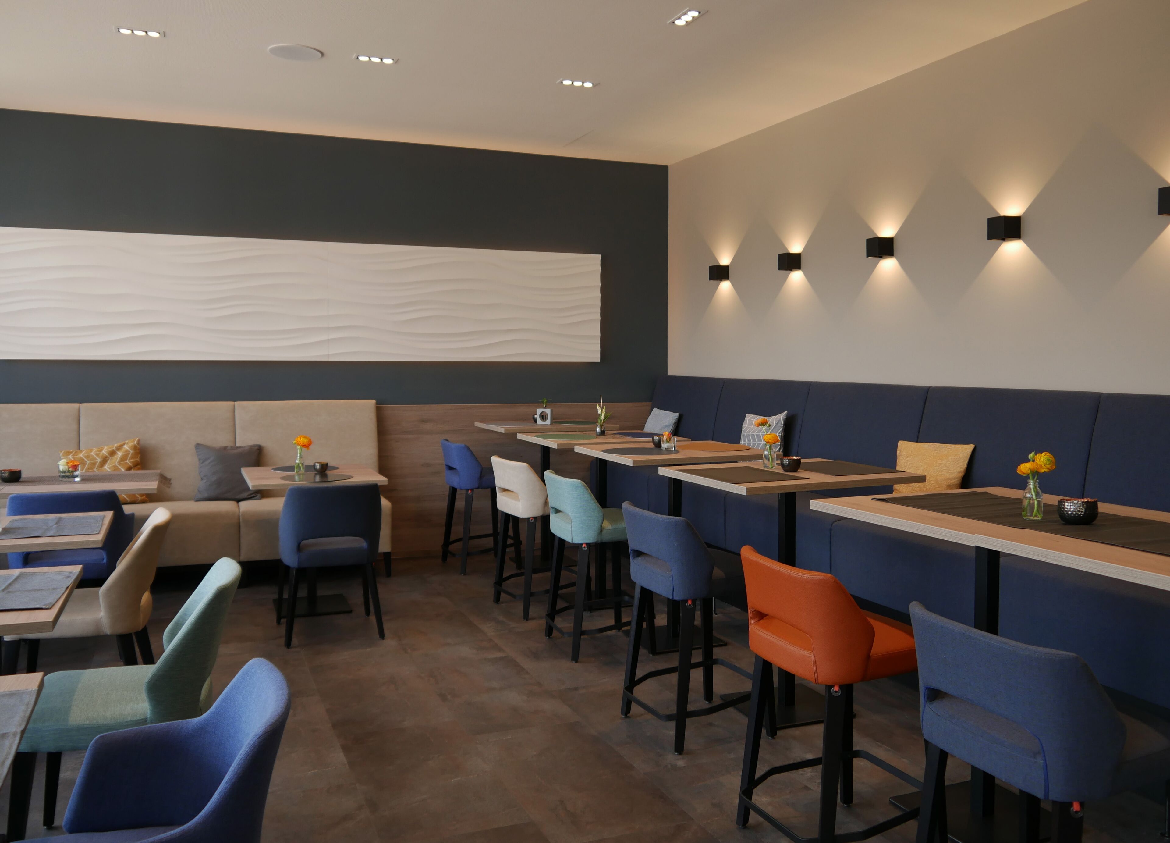 A modern restaurant with booths, bar seating, and contemporary decor.