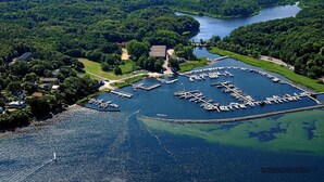 An aerial view of a marina with boats docked, surrounded by lush greenery and a river. - Large penthouse by the sea - box seat on the fjord - (Glücksburg (Ostsee))