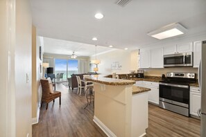 Enjoy cooking in this well-equipped kitchen with an island, sink, and stainless steel appliances.