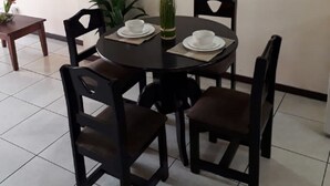 A dining area with a round table, four chairs, a hanging light fixture, a small potted plant, and a wall-mounted globe decoration. - Private Apartment House 2 Bedroom 5 mins SJO Airport Furnished Spacious Kitchen (Alajuela)