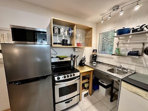Prepare meals in the kitchen with a stainless steel refrigerator, double oven, and sink.