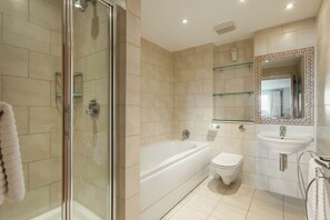 A modern bathroom with a glass-enclosed shower, a freestanding bathtub, a toilet, and a vanity with a mirror. - Crow's Nest - Directly on Poole Quay (Poole)