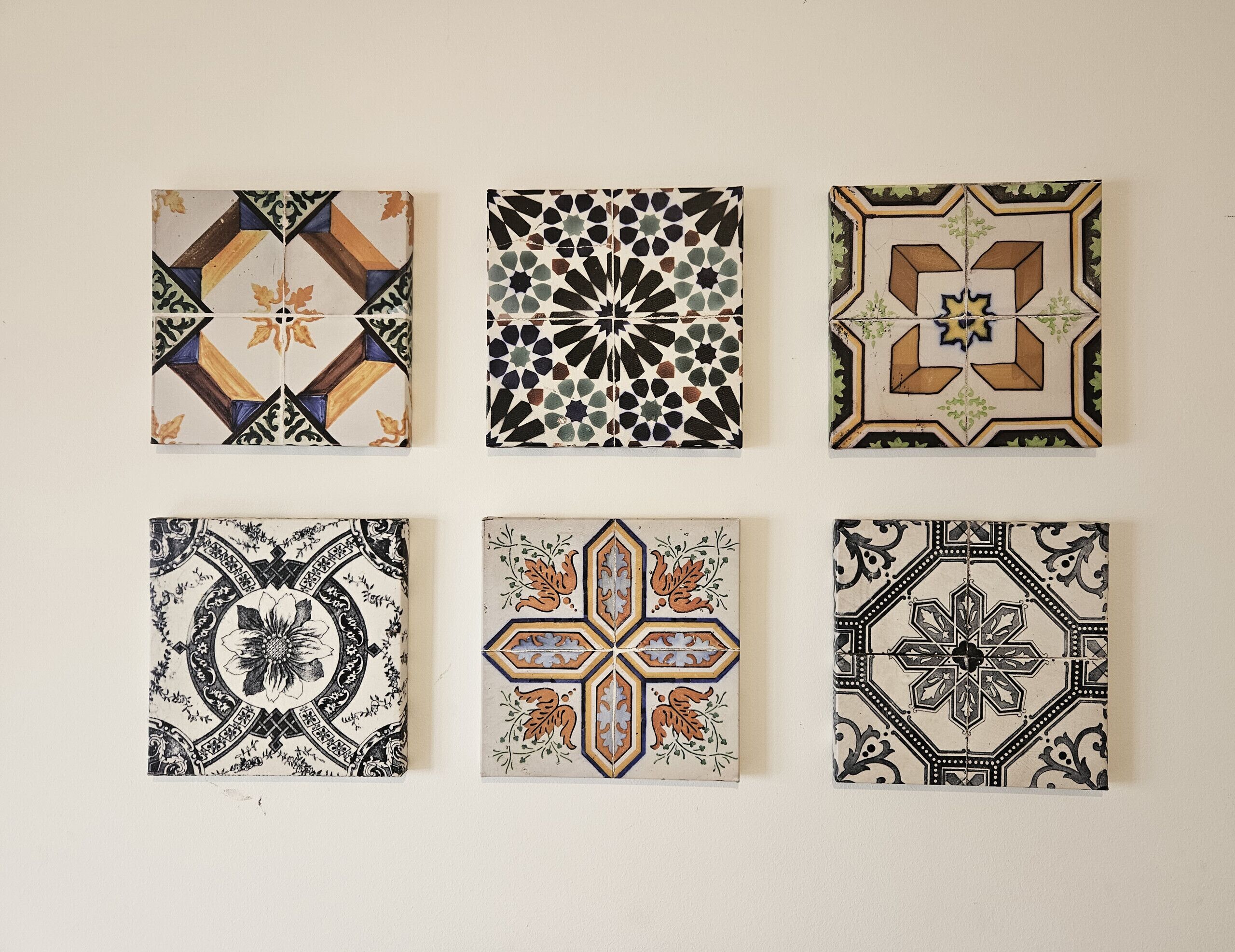 Six square tiles with various geometric and floral patterns.