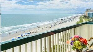 A beach view with a balcony railing and a vase of flowers. - July 4th Week - Ocean Front 1 Bedroom Deluxe Westgate Myrtle Beach Resort (Myrtle Beach)